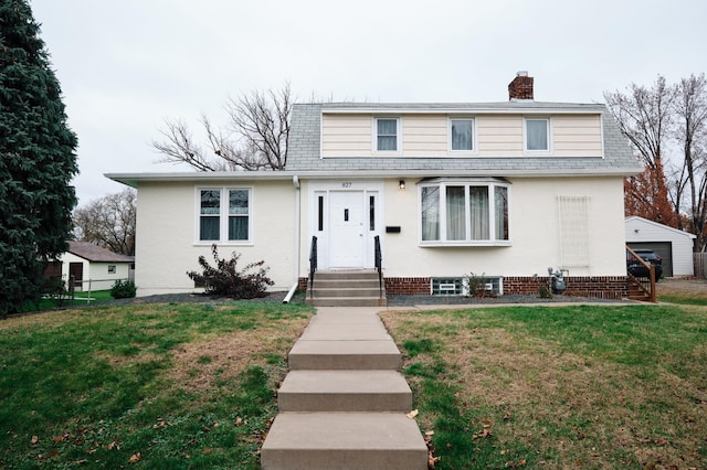 front of property featuring a garage and a front lawn