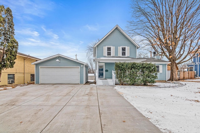 view of property featuring a garage, an outdoor structure, and covered porch