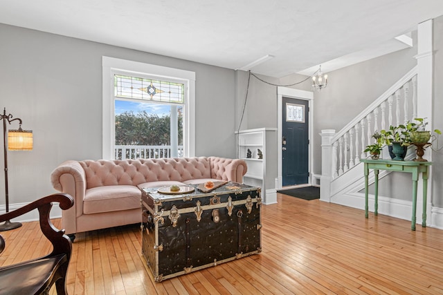 living room featuring hardwood / wood-style flooring and an inviting chandelier