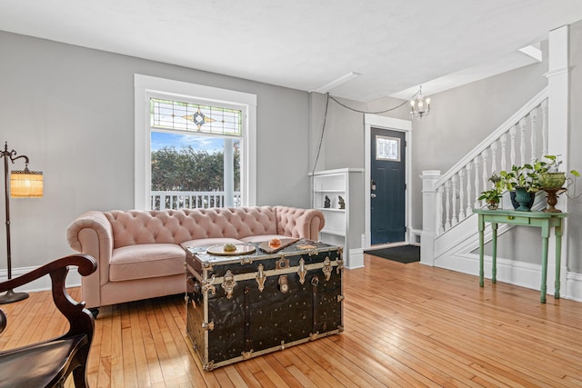 living room with wood-type flooring and a chandelier