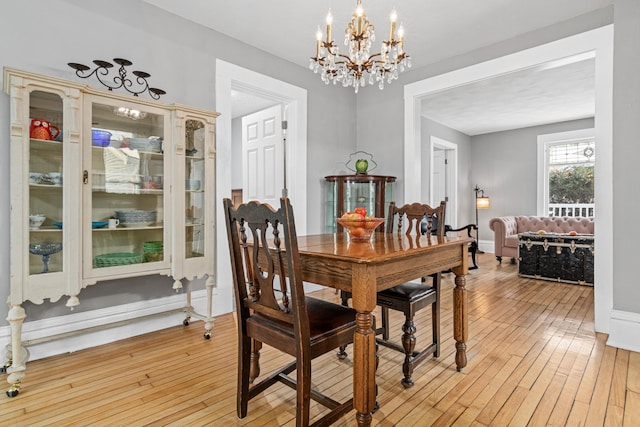 dining room featuring a chandelier and light hardwood / wood-style floors