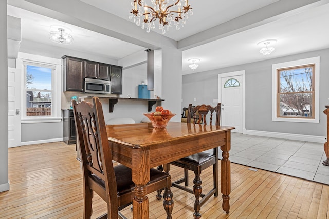 dining room featuring an inviting chandelier and light hardwood / wood-style flooring