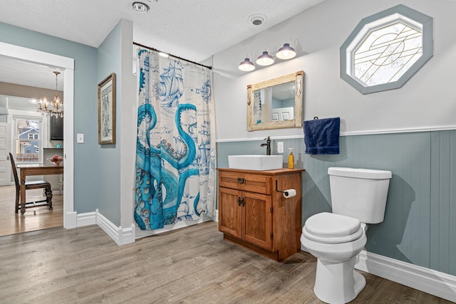 bathroom featuring hardwood / wood-style flooring, toilet, and a textured ceiling