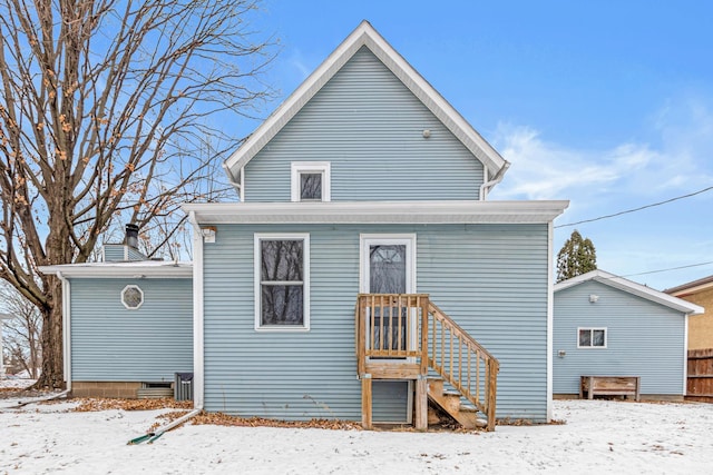 view of snow covered rear of property