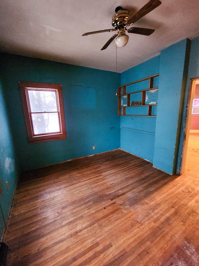 empty room featuring hardwood / wood-style floors and ceiling fan