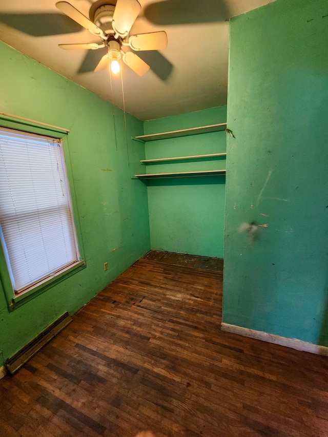 interior space with ceiling fan, a baseboard radiator, and dark hardwood / wood-style floors