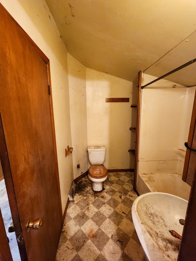 bathroom featuring toilet and lofted ceiling