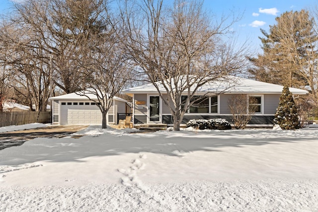 view of front of property featuring a garage and fence