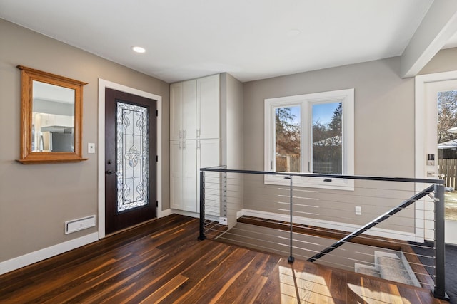 foyer with baseboards, dark wood-type flooring, and recessed lighting