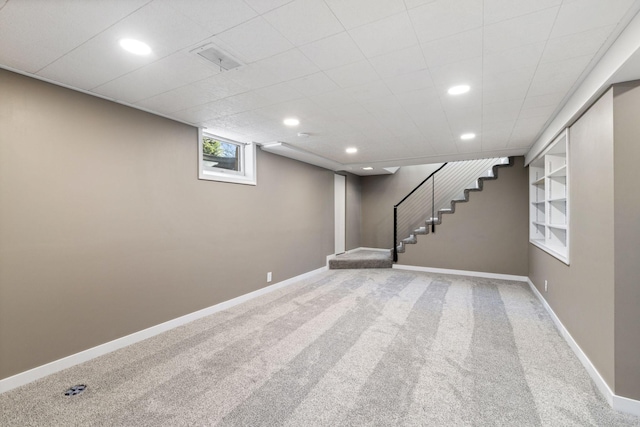 below grade area with stairway, recessed lighting, carpet flooring, and baseboards