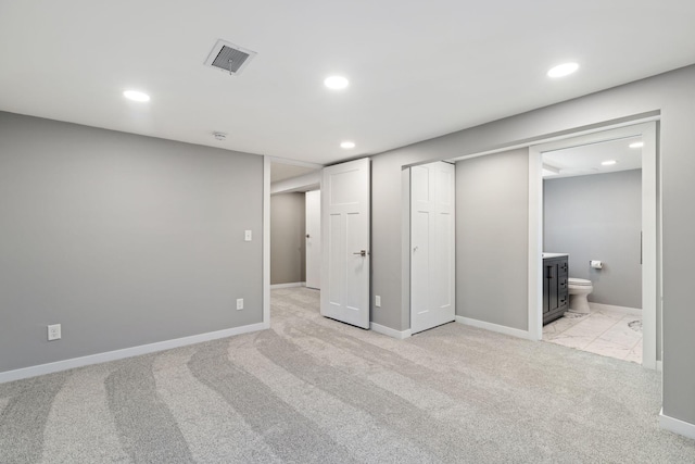 interior space featuring light colored carpet, visible vents, and recessed lighting