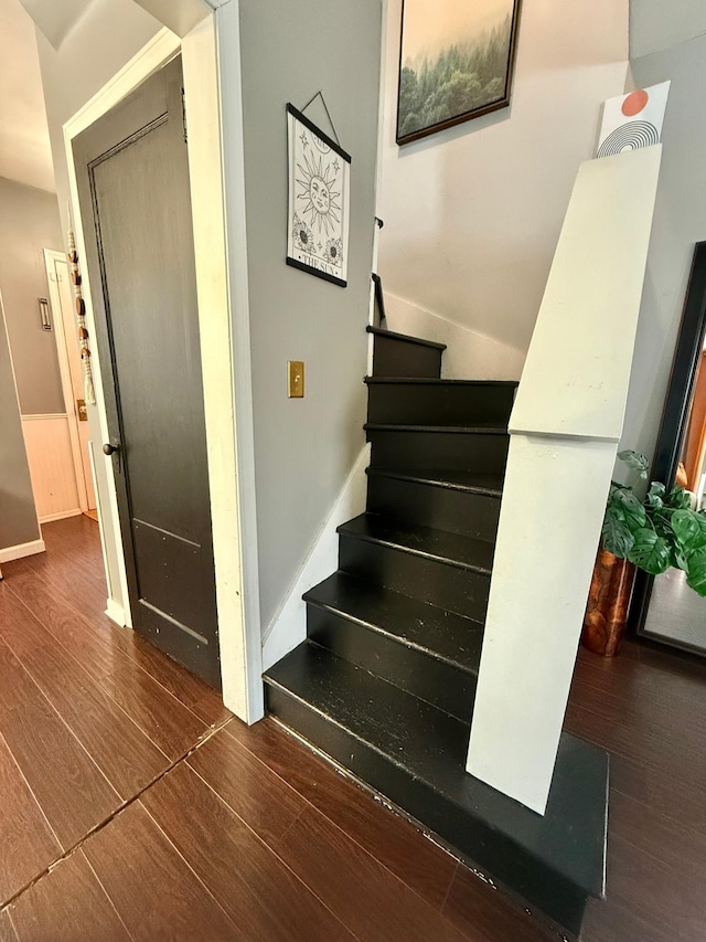 staircase with hardwood / wood-style floors