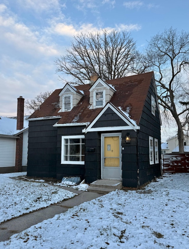 view of front of property featuring a chimney and fence