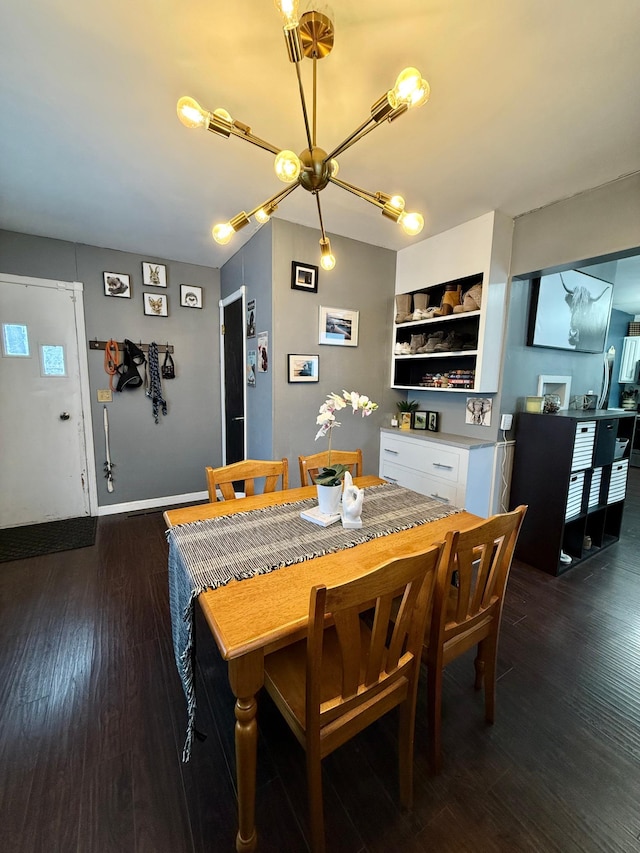 dining room with wood finished floors, an inviting chandelier, baseboards, and visible vents