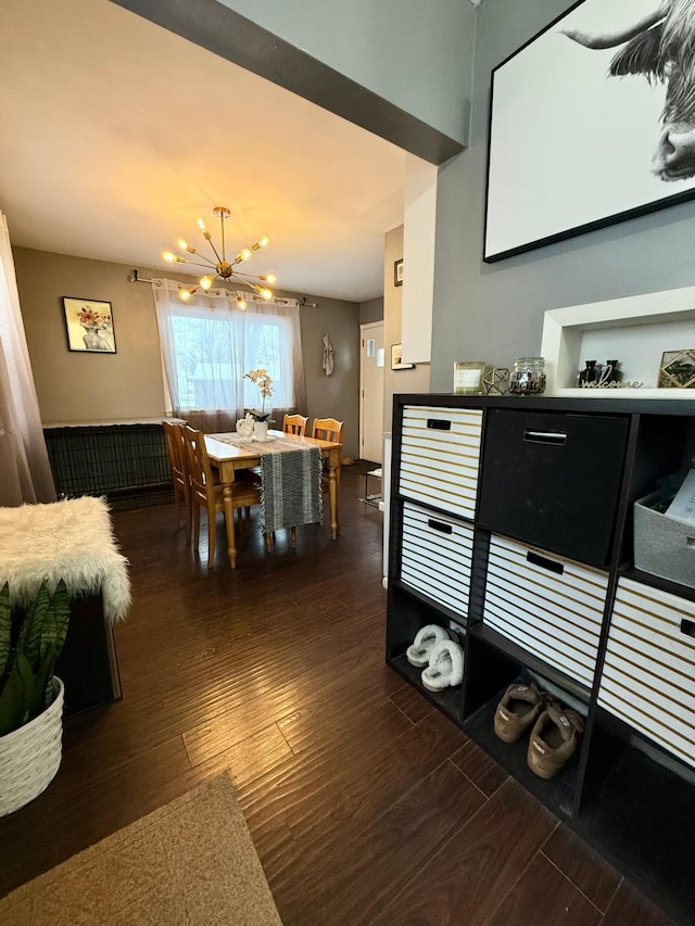 dining space with a notable chandelier and dark wood-style flooring
