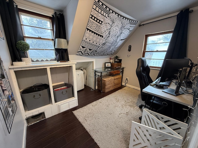 office area featuring lofted ceiling, baseboards, and wood finished floors