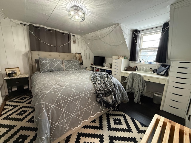 bedroom featuring wood walls