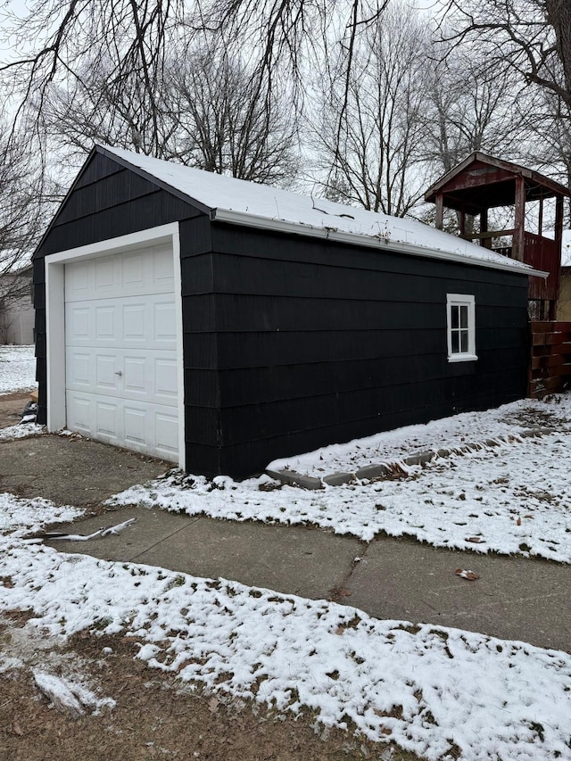snow covered garage with a garage
