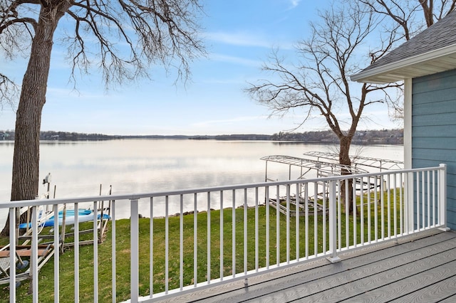 wooden terrace featuring a yard and a water view