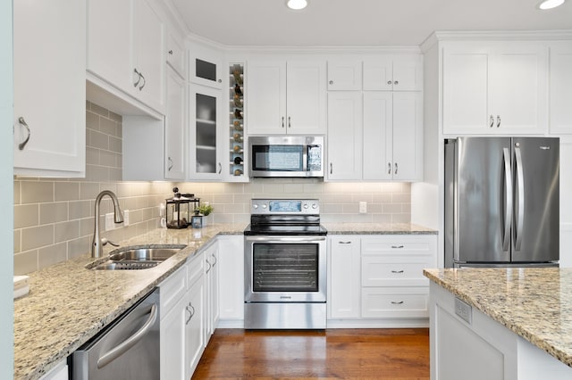 kitchen featuring a sink, stainless steel appliances, white cabinets, glass insert cabinets, and dark wood-style flooring