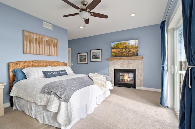 bedroom with visible vents, baseboards, carpet floors, recessed lighting, and a glass covered fireplace