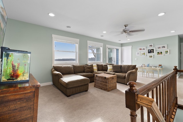 living room with recessed lighting, a ceiling fan, baseboards, and light carpet