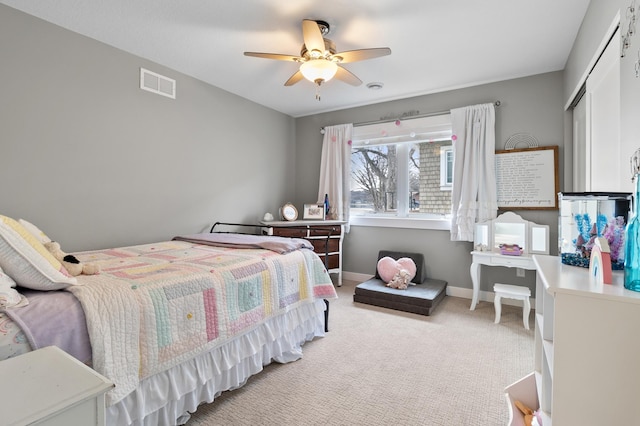 bedroom featuring visible vents, light carpet, baseboards, and ceiling fan