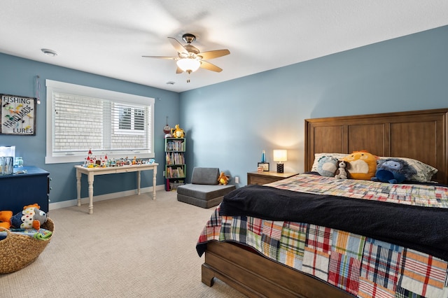 bedroom with light colored carpet, baseboards, and ceiling fan