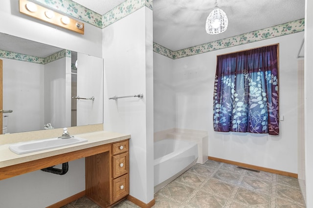 bathroom featuring a bath and a textured ceiling