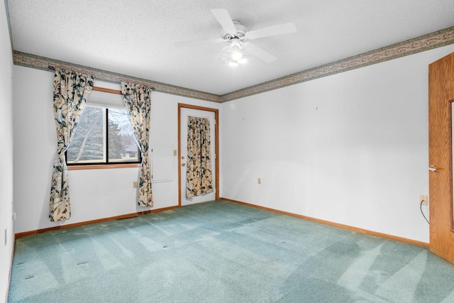 unfurnished room featuring ceiling fan, carpet floors, and a textured ceiling