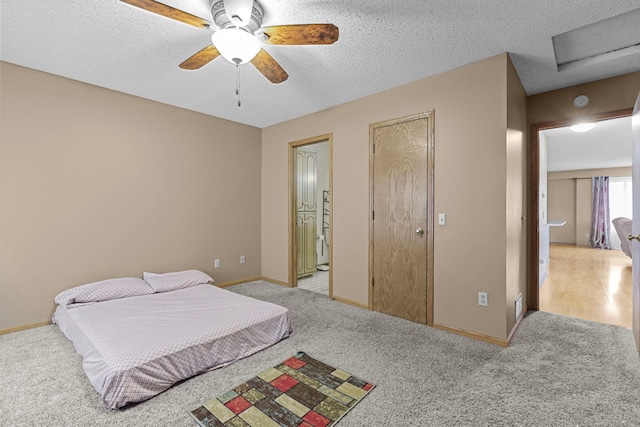 bedroom featuring a textured ceiling, ceiling fan, and light carpet