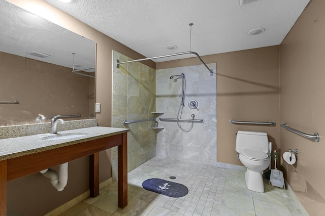 bathroom featuring a textured ceiling, sink, tiled shower, tile patterned flooring, and toilet