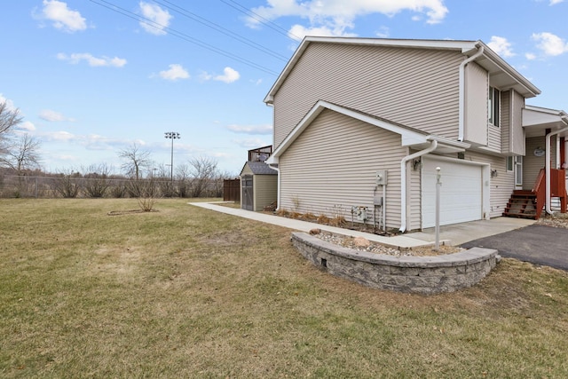 view of property exterior with a garage, a yard, and a shed