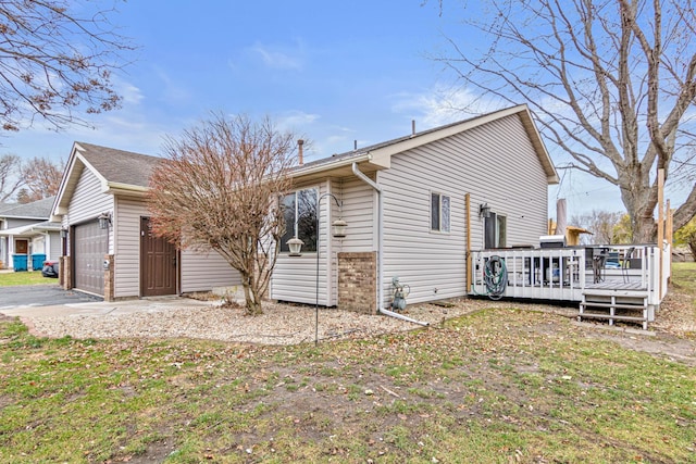 exterior space featuring a garage, a deck, and a front yard