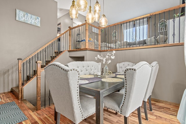 dining area with an inviting chandelier and light hardwood / wood-style flooring