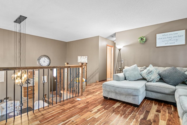 living room featuring a textured ceiling and hardwood / wood-style flooring