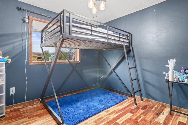 bedroom with hardwood / wood-style flooring