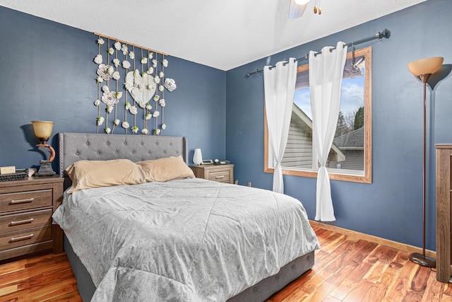 bedroom with hardwood / wood-style flooring and ceiling fan