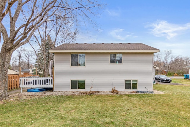 back of house with a yard and a wooden deck