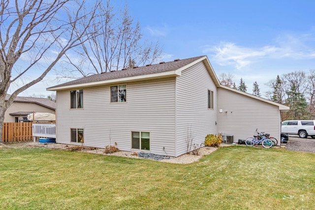 rear view of property featuring a lawn