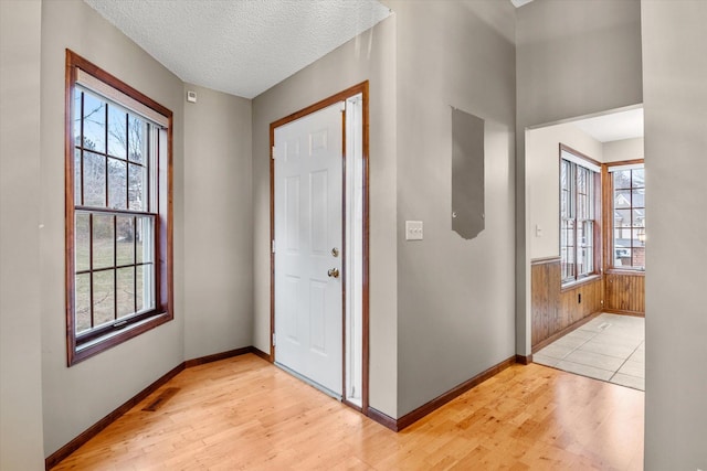 foyer featuring light hardwood / wood-style floors and a textured ceiling