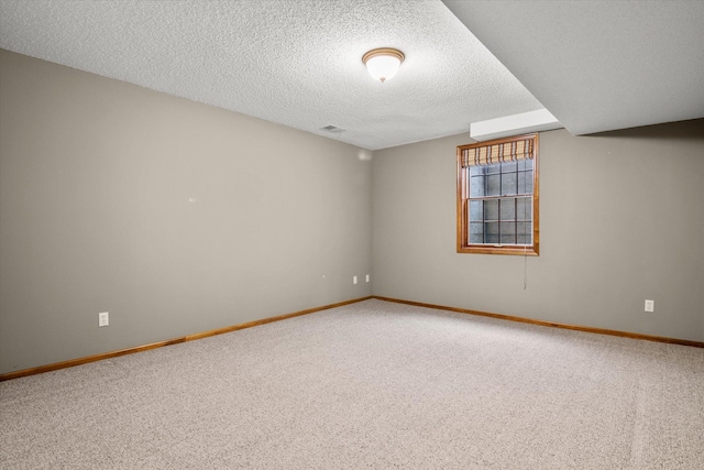 carpeted spare room featuring a textured ceiling