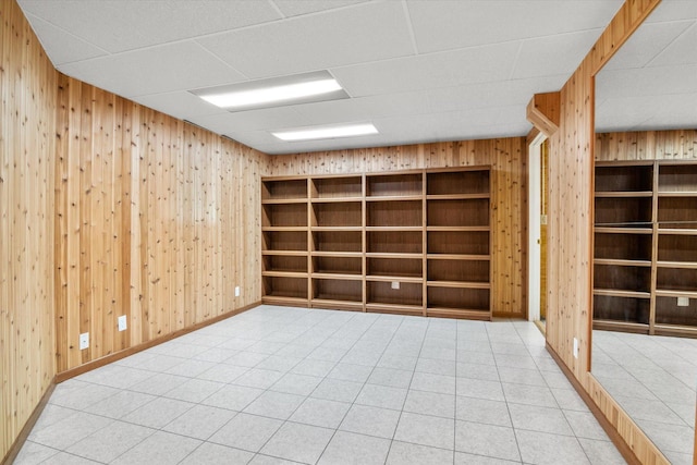 spare room featuring wooden walls and built in features