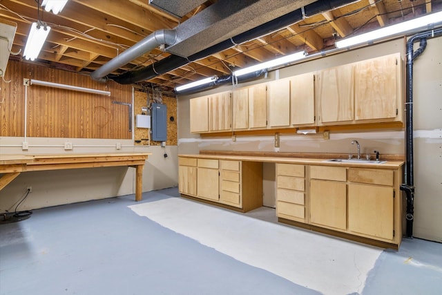 basement with sink, electric panel, and a workshop area