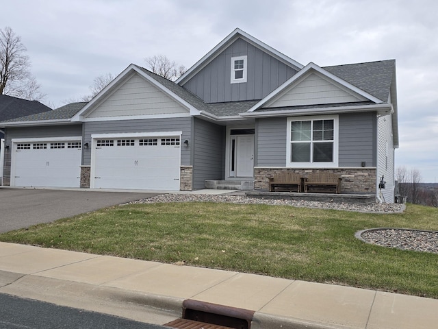 craftsman-style home featuring a garage and a front lawn