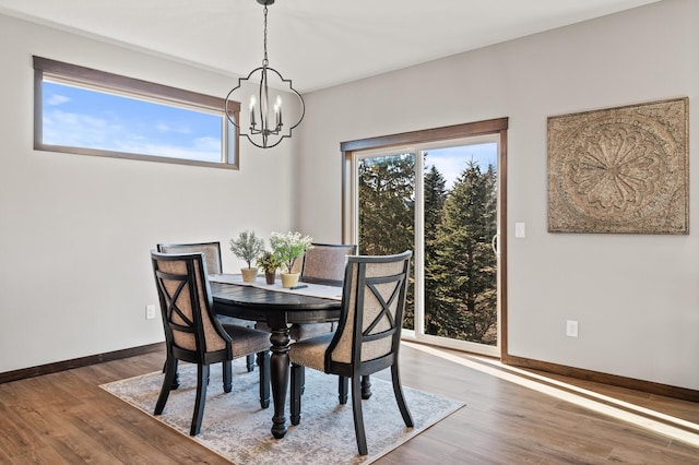 dining room with a notable chandelier and dark wood-type flooring