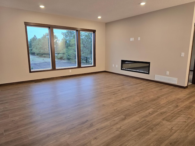 unfurnished living room featuring hardwood / wood-style floors