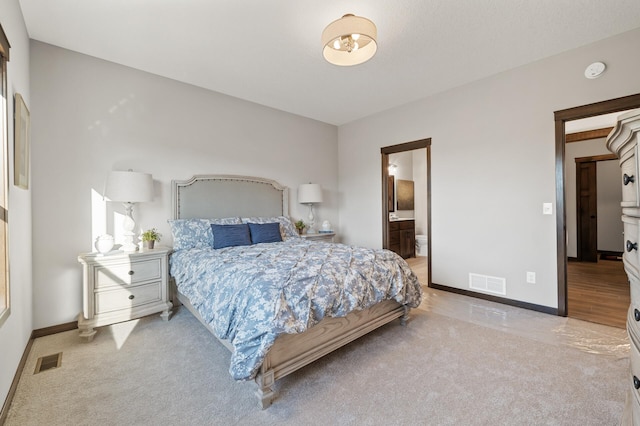 carpeted bedroom featuring ensuite bathroom