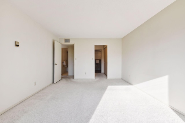 unfurnished room with light carpet