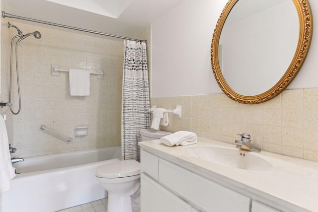 full bathroom with tile patterned floors, vanity, toilet, and tile walls